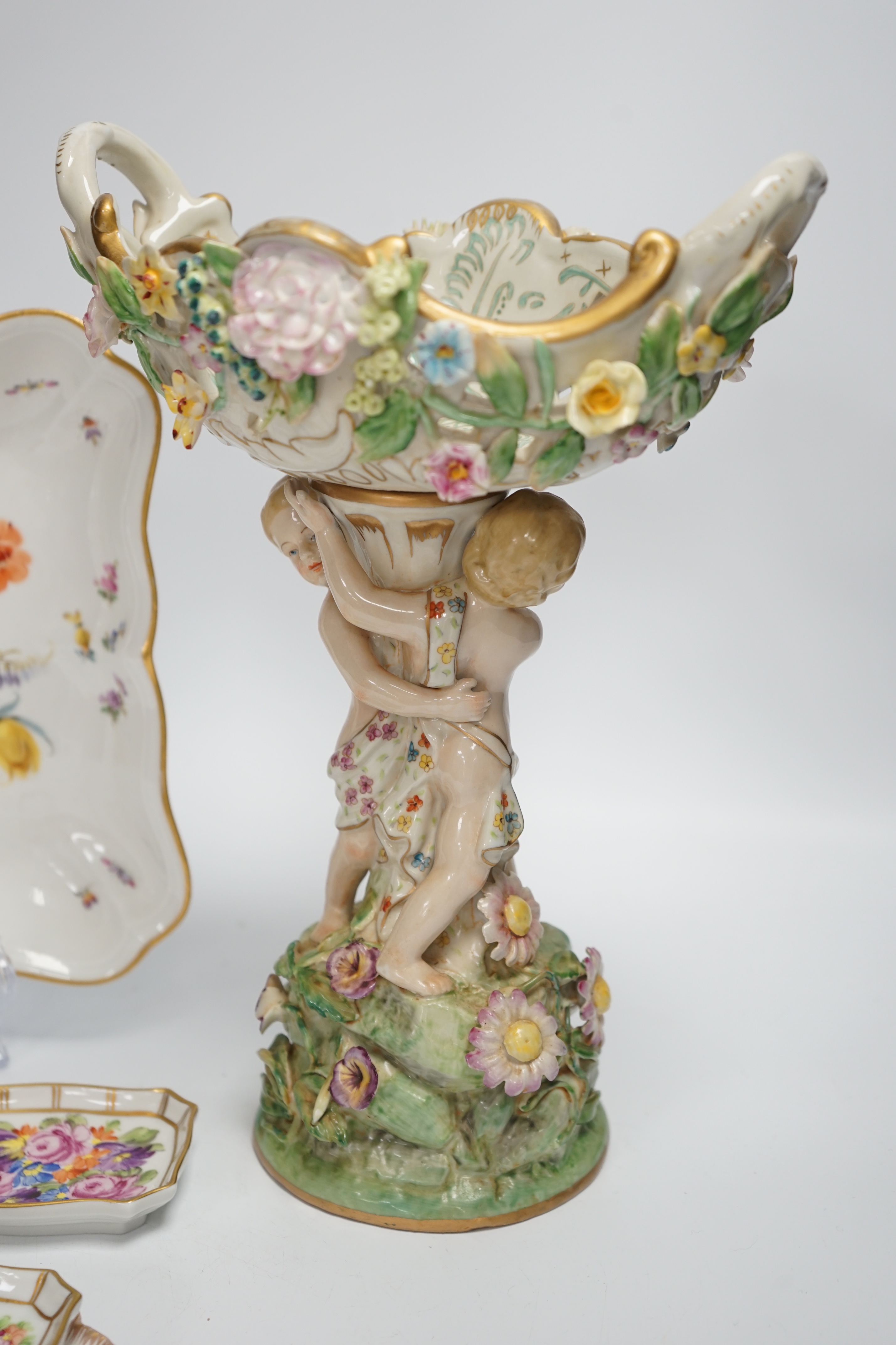 A German porcelain figural centrepiece, a Meissen floral dish, and various Dresden dishes, tallest 29cm